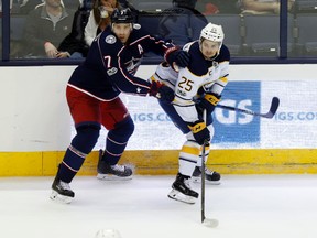 Buffalo Sabres forward Seth Griffith, right, of Wallaceburg passes the puck in front of Columbus Blue Jackets' Jack Johnson during the third period in Columbus, Ohio, on Wednesday, Oct. 25, 2017. (PAUL VERNON/The Associated Press)