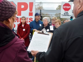 From left, Stacie Littlejohn, Jamie Littlejohn, Claire Champ, Yvonne Brooks, and Darlene Ford were some of the dozens of protesters in Dutton Wednesday night. It was their last chance to rally against representatives from Invenergy, the Chicago-based company looking to build a wind farm in the rural municipality. (Louis Pin // Times-Journal)