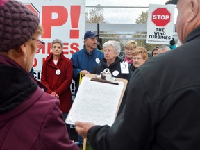 From left, Stacie Littlejohn, Jamie Littlejohn, Claire Champ, Yvonne Brooks, and Darlene Ford were some of the dozens of protesters in Dutton Wednesday night. It was their last chance to rally against representatives from Invenergy, the Chicago-based company looking to build a wind farm in the rural municipality.