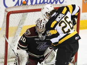 Peterborough Petes' goalie Dylan Wells makes a save against Kingston Frontenacs' Ted Nichol during Ontario Hockey League action at the Memorial Centre in Peterborough. (Clifford Skarstedt/Postmedia Network)