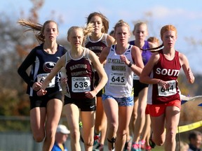Tori Bouck of Banting and Zoe Burke of South lead an opening lap pack that includes eventual winner Rebecca DeKay of Banting (at rear) and Elizabeth Drake of St. Mikes during the senior girls WOSSAA cross-country race at St. Annes Catholic High School in Clinton on Thursday October 26, 2017. Burke, whose younger brother Evan won the senior boys, placed second behind DeKay, while Bouck finished third. (MIKE HENSEN, The London Free Press)