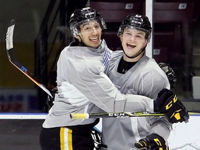 Jordan Kyrou, left, and Drake Rymsha enjoy a light moment during the Sarnia Sting's practice at Progressive Auto Sales Arena in Sarnia, Ont., on Wednesday, Oct. 25, 2017. (MARK MALONE/Postmedia Network)