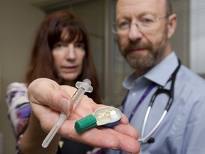 Dr. Sharon Koivu and Dr. Michael Silverman show drug paraphernalia, including a small container for heating crushed drugs in water, then a small white sponge is used to absorb the drug which is then drawn into a syringe and injected. The danger of HIV and endocarditis comes from using the sponge more than once, as it has blood from the first user, and the HIV virus can live in the sponge. (Mike Hensen/The London Free Press)