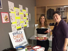 Cindy Gibb and Karin Pennington, 2017 co-chairs of the United Way campaign at Department of Fisheries and Oceans and Canadian Coast Guard in Sarnia load up their baked potatoes at the DFO/CCG baked potato bar sponsored by Philly Cheese Jakes. Next week, the United Way campaign team is hosting a Nacho Bar to raise money in addition to the staff pledge drive. (Handout/The Observer)