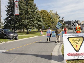 Local college faculty walk a picket line and speak with drivers entering all three entrances to St. Lawrence College Kingston campus on October 19. Julia McKay/The Whig-Standard/Postmedia Network