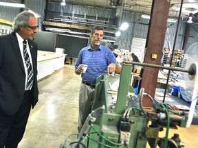 Mayor Randy Hope (left) takes a tour of Quality Custom Covers with co-owner Charles Manders on Oct. 26. Hope proclaimed the business as industry of the month on behalf of the Chatham-Kent Chamber of Commerce.