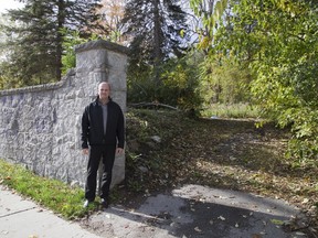 George Bikas of Drewlo Holdings stands at 661 Talbot St. in London where the company plans build an apartment building. He said the stone retaining wall won?t be saved as plans are to make the surface level to the sidewalk. (DEREK RUTTAN, The London Free Press)