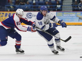 Dmitry Sokolov, right, of the Sudbury Wolves, attempts to skate around Adam Kadlec, of the Windsor Spitfires, during OHL action at the Sudbury Community Arena in Sudbury, Ont. on Friday October 27, 2017. John Lappa/Sudbury Star/Postmedia Network