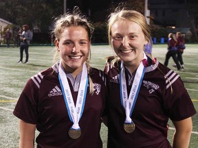 Local rugby players Emily Babcock (left) of Belleville and Annabelle Clements, of Trenton, celebrate Ottawa's 25-7 win over Laval in the RSEQ women's rugby final Friday night. Gee Gees will play next week at Nationals in Lethbridge. (Submitted photo)