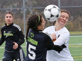 Darby Perry, left, of Algonquin Thunder, and Rebecca Spratt, of Humber Hawks, collide while going for the ball during women's soccer action at the OCAA championship final at James Jerome Sports Complex in Sudbury, Ont. on Saturday October 28, 2017. John Lappa/Sudbury Star/Postmedia Network