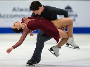 Tessa Virtue and Scott Moir of Canada perform their free dance on Saturday. (Geoff Robins / AFP / Getty Images)