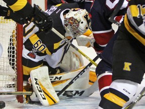 Despite the commotion around him, Kingston Frontenacs goalie Jeremy Helvig eyes the puck during the first period of Ontario Hockey League action at the Rogers K-Rock Centre on Sunday. (Steph Crosier/The Whig-Standard)