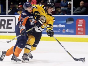 Sarnia Sting's Adam Ruzicka, right, shoots while being hit by Flint Firebirds' Jack Wismer in the first period at Progressive Auto Sales Arena in Sarnia, Ont., on Sunday, Oct. 29, 2017. (Mark Malone/Postmedia Network