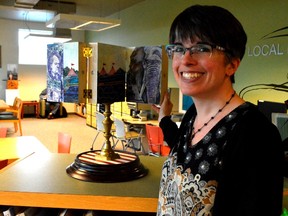 Dana Vanzanten shows off one of Ron Milton's latest art pieces, an homage to Jumbo, on the upper floor of the St. Thomas Public Library. It's one of six interactive installments currently at the library, designed by Milton for St. Thomas as part of the city's Canada 150 celebration. (Louis Pin // Times-Journal)