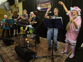 Members of the Southern Ontario Ukelele Players, some dressed for Halloween, perform during a recent weekly practice at the London Music Club. The group, which boasts 340 members, is one of three nominees for a Pillar award in the impact category. (MORRIS LAMONT, The London Free Press)
