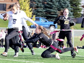 Morgan McLeod of the Lively Hawks tags out Allie Weiler of the Marymount Academy Regals during girls high school flag football action in Sudbury, Ont. on Monday October 16, 2017. Gino Donato/Sudbury Star/Postmedia Network