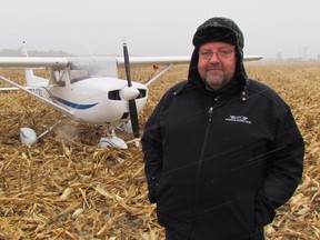 Windsor pilot John Cundle stands Tuesday next to Hasel, his two-seater airplane that made an emergency landing Thursday night in a cornfield on Plank Road, near Sarnia. Cundle walked away uninjured, and Hasel was set to be removed from the field Tuesday. (Paul Morden/Sarnia Observer/Postmedia Network)