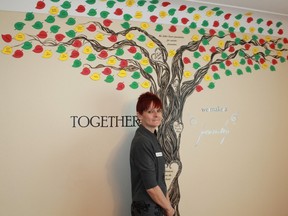 Deker Bauer Foundation CEO Teresa Ingles stands beside a painted tree inside the Deker Bauer Foundation Resource Centre, a tree that represents the individuals, companies and organizations who helped make her dream come to life.
CARL HNATYSHYN/SARNIA THIS WEEK