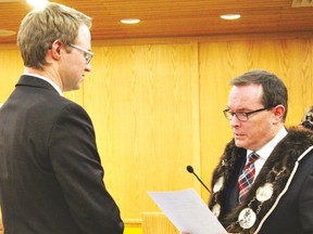 Outgoing Drayton Valley Mayor Glenn McLean reads incoming Mayor Michael Doerksen the Oath of Office before a standing rooom only audience in Council Chambers on October 23.