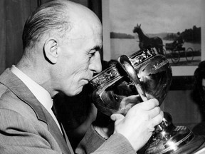 The legendary Eddie Shore sips from the Calder Cup after a Springfield Indians triumph in the early 1960s. As a GM, Shore won seven Calder Cup titles in the AHL. (AHL.com)