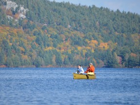 Canoeists enjoy the crisp air and vivid hues on George Lake in late October. Between a recent visit by British journalists and exposure at an upcoming outdoors show in England, Killarney Provincial Park and its neighbouring waters in Georgian Bay are receiving a lot of international attention. (Jim Moodie/Sudbury Star)