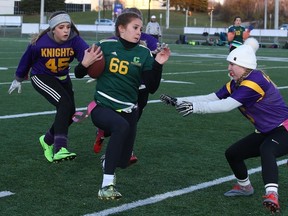 Kona Haas of the Confederation Chargers makes a run with the ball while being pursued by members of the Lo Ellen Knights, during high school flag football semi-final action in Sudbury, Ont. on Tuesday October 31, 2017. Gino Donato/Sudbury Star/Postmedia Network