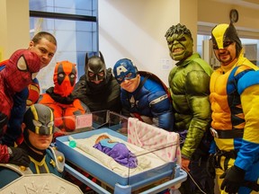 The Greater Sudbury Police tactical unit dressed as superheroes, visit patients in the pediatric unit and NICU at Health Sciences North on Monday. Supplied photo