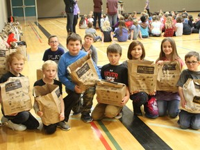 Mannville School students pictured above with the food bags they donated to the Mannville Food Bank in an effort to drive away hunger with the Farm Credit Canada (FCC) community investment program on October 27.