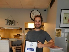Flippin’ Eggs owner Giany Liotis with his framed award, ‘Best Airport Restaurant’. Unaware of the nomination, let alone of winning the award, COPA 45 Goderich members surprised Giany with the award today. (Kathleen Smith/Goderich Signal Star)