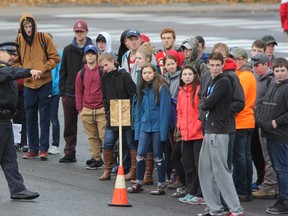 Const. Rick Martin of the OPP shows Grade 11 and 12 students from Sydenham High School the different stopping distances required when driving in different weather conditions at a Winter Driving Safety Community Partners Presentation on Wednesday. (Steph Crosier/The Whig-Standard)