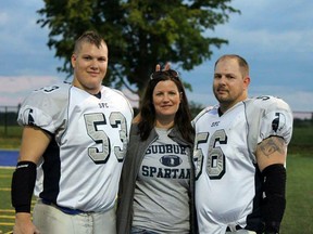 Troy, Jillian and Paul Kingsbury have a little fun while posing for a photo at the football field. The family will host a cancer fundrasier at Wacky Wings on Nov. 8 at 7 p.m. Photo supplied