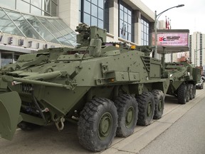 Two London-built General Dynamics Land Systems light armoured vehicles make their presence known outside the London Convention Centre on York Street during the Best Defence Conference on Wednesday. (MIKE HENSEN, The London Free Press)