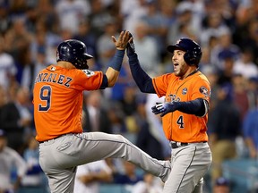 Houston Astros' George Springer (right) celebrates with Marwin Gonzalez after hitting a two-run home run during the second inning against the Los Angeles Dodgers in Game 7 of the 2017 World Series at Dodger Stadium on Nov. 1, 2017 in Los Angeles. (Ezra Shaw/Getty Images)