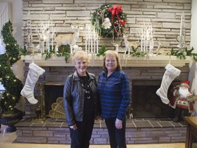 Pat Martyn, co-ordinator of decorations for the St. Thomas Christmas Tour of Homes, left, and decorator MaryAnn Verberne of McLennan Flowers check out 6331 Fairview Rd. in St. Thomas. (DEREK RUTTAN, The London Free Press)