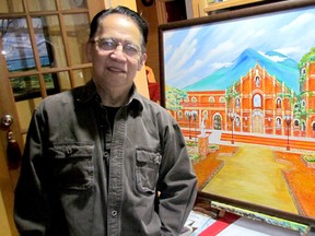 Sarnia artist Jorge de Guzman is shown with one of the paintings included in an exhibition of his work on display this month at the Christina Street Market in the former Taylor's building in downtown Sarnia.
 Paul Morden/Sarnia Observer/Postmedia Network