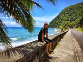 Brendan Richmond sits on a wall near the town of Grand Bay along the southeast coast of Dominica during his trip to the island last year. (Trudy Scott Prevost/Submitted Photo)