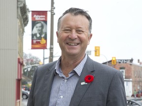 Central Huron Mayor Jim Ginn with a banner honouring the war time service of Margaret H. (Middleton) Counter in Clinton Ont. on Thursday November 2, 2017. (DEREK RUTTAN, The London Free Press)