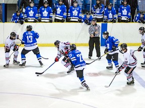 Sarnia Legionnaires forward Greg Hay (No. 8 in white) carries the puck away from three London Nationals during Jr. 'B' hockey action Thursday at the Sarnia Arena. A little later Hay burst into the clear for a breakaway goal that helped the Legionnaires edge the Nats 3-2. (Photo by Shawna Lavoie)