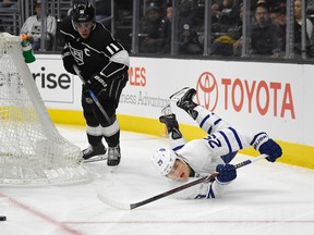 Toronto Maple Leafs center William Nylander, right, falls as he passes the puck while under pressure from Los Angeles Kings center Anze Kopitar, of Slovenia, during the first period of an NHL hockey game, Thursday, Nov. 2, 2017, in Los Angeles. (AP Photo/Mark J. Terrill)