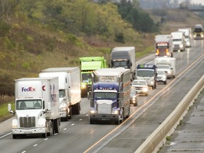 Transport trucks head east on Highway 401 near London. (MIKE HENSEN, The London Free Press)