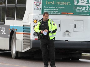 Sgt. Darren Keuhl, of the Kingston Police, stands over clothing belonging to a man who was struck by a Kingston Transit bus early Friday morning. Ian MacAlpine, Kingston Whig-Standard, Postmedia Network