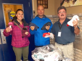 Amber Leighton, left, George O'Mahony and Myles Vanni pose at the Inn of the Good Shepherd recently. O'Mahony, who runs the Foot Care Centre in Sarnia, helped collect and donate more than 1,100 pairs of socks to the Inn via the centre's annual Socktober collection drive. (Submitted)