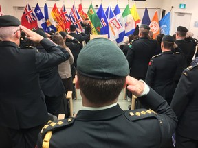 Canadian Forces members salute during the opening and dedication of the new Paul A. Mayer Building, which houses the Peace Support Training Centre on Canadian Forces Base Kingston in Kingston, Ont. on Friday, Nov. 3, 2017. 
Elliot Ferguson/The Whig-Standard/Postmedia Network