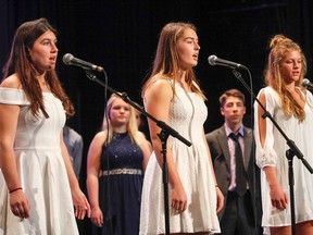 LaSalle Secondary School students Kate Anderson Grade 12, Alyssa Labrie Grade 11 and Hope Murphy Grade 10 perform a Leonard Cohen song during the Canadian Crystal rehearsal in the Kingston Collegiate auditorium in Kingston on Wednesday. (Julia McKay/The Whig-Standard)