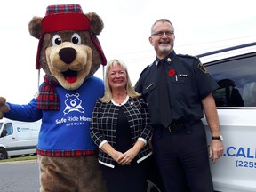 Stewie, the mascot; Lesli Green of Safe Ride Home Sudbury; and Deputy Chief Al Lekun of the Greater Sudbury Police Service. (Keith Dempsey/For The Sudbury Star)