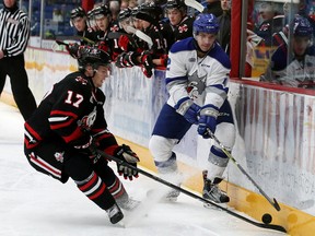 Doug Blaisdell, right, of the Sudbury Wolves, and William Lochead, of the Niagara IceDogs, battle for the puck during OHL action at the Sudbury Community Arena in Sudbury, Ont. on Friday November 3, 2017. John Lappa/Sudbury Star/Postmedia Network