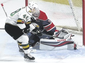 Saginaw Spirit goalie Evan Cormier gets enough of his left pad on the puck to deny a close-in chance by Knights forward Sam Miletic during the first period of their OHL game at Budweiser Gardens on Friday night. The Knights lost 6-5 in overtime. (MIKE HENSEN, The London Free Press)
