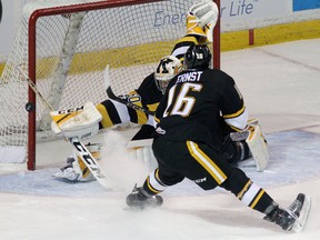 Kingston Frontenacs' Jeremy Helvig makes a save on Sarnia Sting Jordan Ernst during Ontario Hockey League action at the Rogers K-Rock Centre on Friday. (Ian MacAlpine/The Whig-Standard)