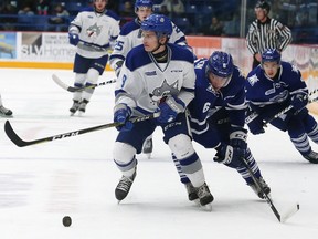 Dawson Baker, left, of the Sudbury Wolves, attempt to evade Stephen Gibson, of the Mississauga Steelheads, during OHL action at the Sudbury Community Arena in Sudbury, Ont. on Saturday November 4, 2017. John Lappa/Sudbury Star/Postmedia Network
