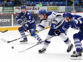 Blake McConville, left, of the Sudbury Wolves, fires the puck on net as Nicolas Hague, of the Mississauga Steelheads, attempts to block the shot during OHL action at the Sudbury Community Arena in Sudbury, Ont. on Saturday November 4, 2017. John Lappa/Sudbury Star/Postmedia Network